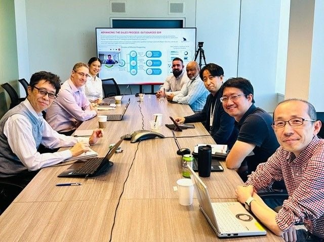 A professional team from Raycom collaborating in a modern office.